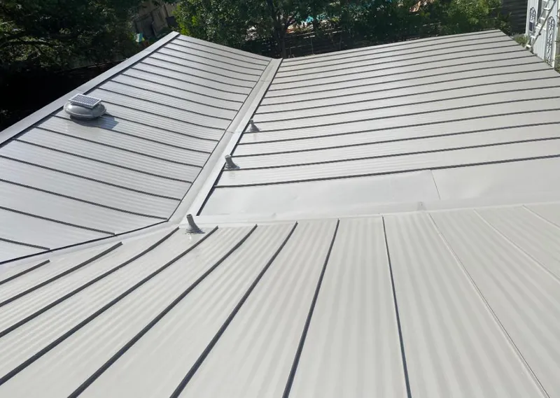 Solar attic fan installed on a metal roof for Roof Ventilation in Jarrell